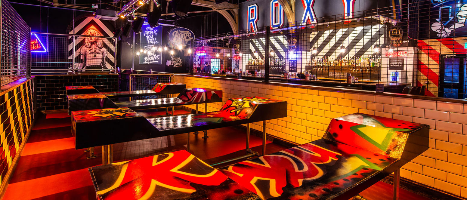 A bar with beer pong tables